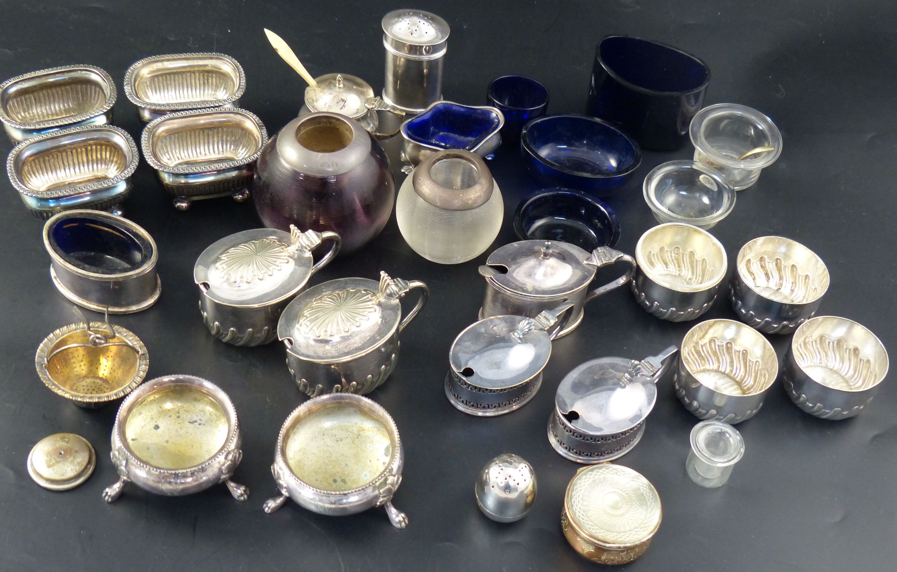 A group of assorted plated condiments, two silver condiments, a silver strainer two match tidies, etc.